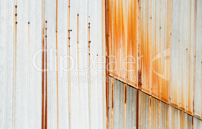 Metal siding with vertical rust stains.