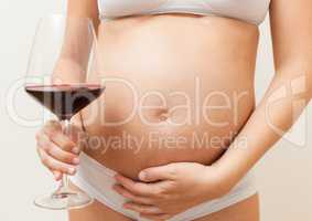 Pregnant woman with glass of red wine