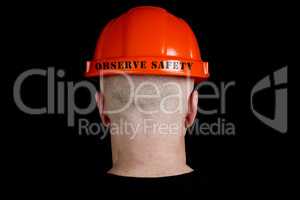 Construction worker in hard hat with an inscription observe safe