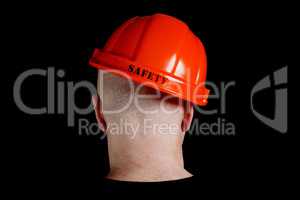 Construction worker in hard hat with an inscription safety