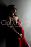 Studio photo of pregnant woman bared her breast