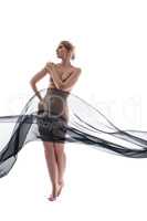 Naked woman gracefully posing with flying cloth