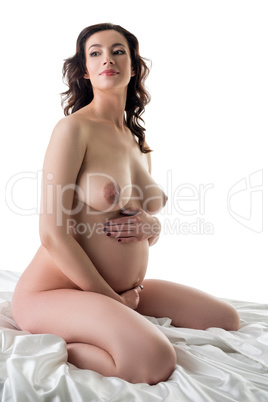 Beautiful expectant mother posing nude in studio