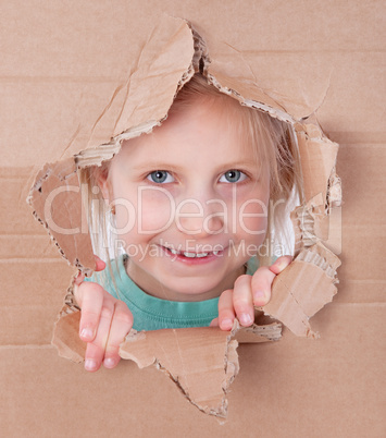 kid portrait in torn paper hole