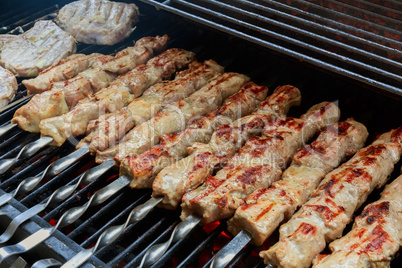 fresh hot grilled chicken shish kebab barbecue on grid over