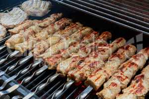 fresh hot grilled chicken shish kebab barbecue on grid over