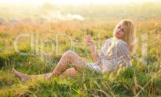 Girl is relaxing on green field