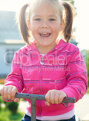 Cute little girl is swinging on see-saw