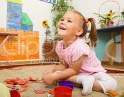 Little girl is playing in preschool