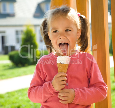 Little girl is eating ice-cream