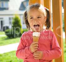 Little girl is eating ice-cream