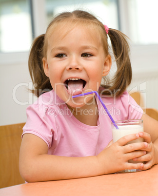 Little girl is drinking milk