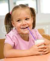 Little girl is drinking milk
