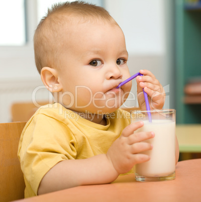 Little boy is drinking milk