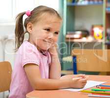 Little girl is drawing with felt-tip pen