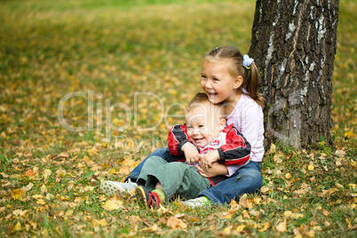 Children are playing in autumn park