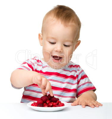 Cute little boy with strawberries