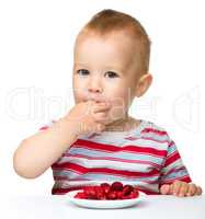 Happy little boy with strawberries