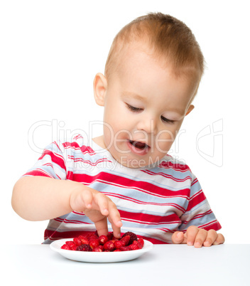 Cute little boy with strawberries