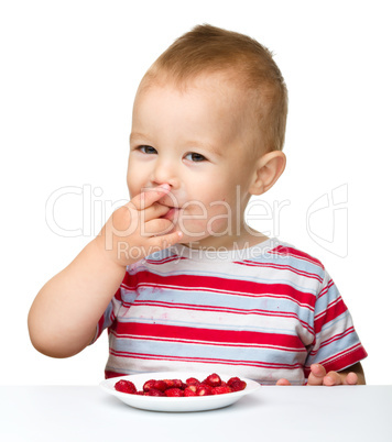 Happy little boy with strawberries