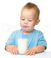 Cute little boy is drinking milk