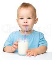 Cute little boy is drinking milk