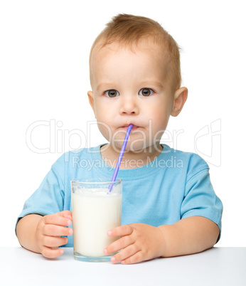 Cute little boy is drinking milk