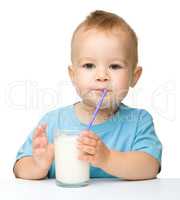 Cute little boy is drinking milk