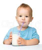 Cute little boy is drinking milk