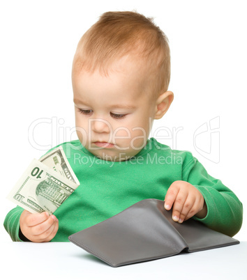Cute little boy is counting money