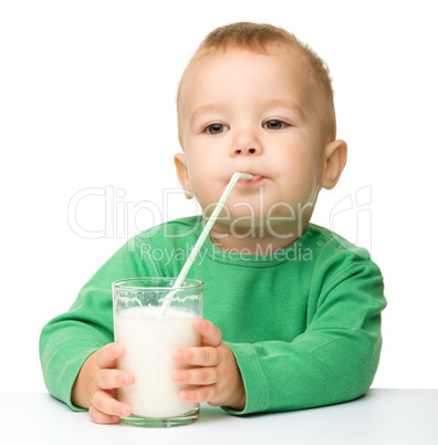 Cute little boy is drinking milk