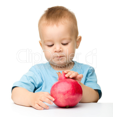 Little boy with pomegranate