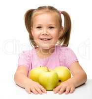 Little girl with apples