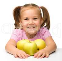 Little girl with apples