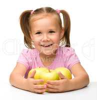 Little girl with apples