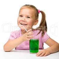 Little girl with a glass of tarragon drink