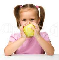 Little girl with yellow apple