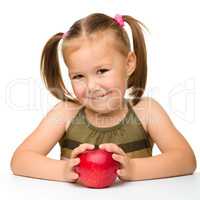 Little girl with red apple