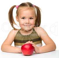 Little girl with red apple