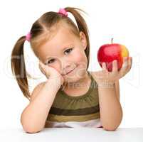 Little girl with red apple