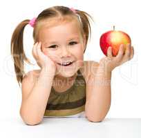 Little girl with red apple