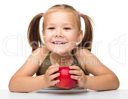 Little girl with red apple