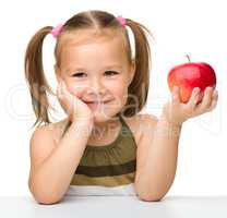 Little girl with red apple