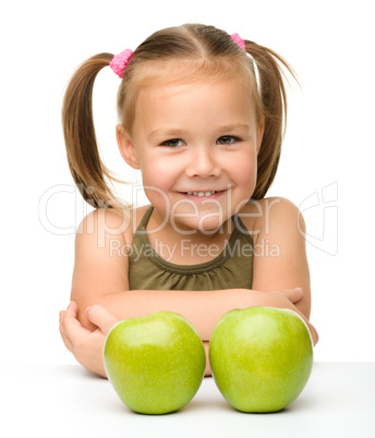 Little girl with two green apples Little girl with two green apples