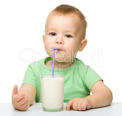 Cute little boy is drinking milk