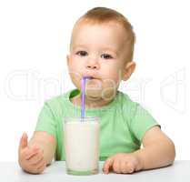 Cute little boy is drinking milk
