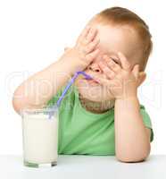 Cute little boy is drinking milk