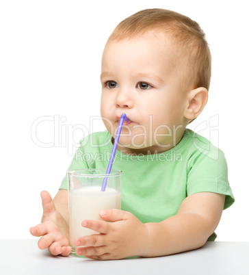 Cute little boy is drinking milk