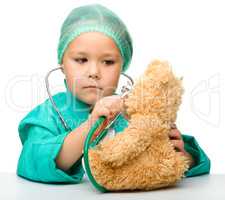 Little girl is playing doctor with stethoscope