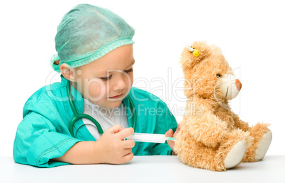 Little girl is playing doctor with syringe
